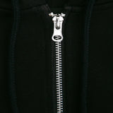 Close-up of a silver zipper on a black background