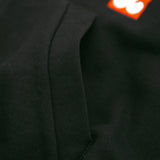 Close-up of a black fabric texture with a brand logo in the corner.
