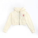 Beige hoodie with a small red logo on a white background