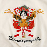 Embroidered design with traditional elements and 'Business prosperity' text on a white background