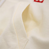 Close-up of a beige fabric with a brand logo in the corner