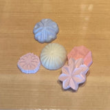 Pastel wagashi-shaped aroma stones on a wooden surface