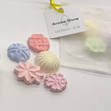 Assorted pastel aroma stones in wagashi shapes with HONO-KA Aroma Stone tag