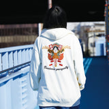 Person wearing a white hoodie with a colorful design and text on the back, standing on a bridge.